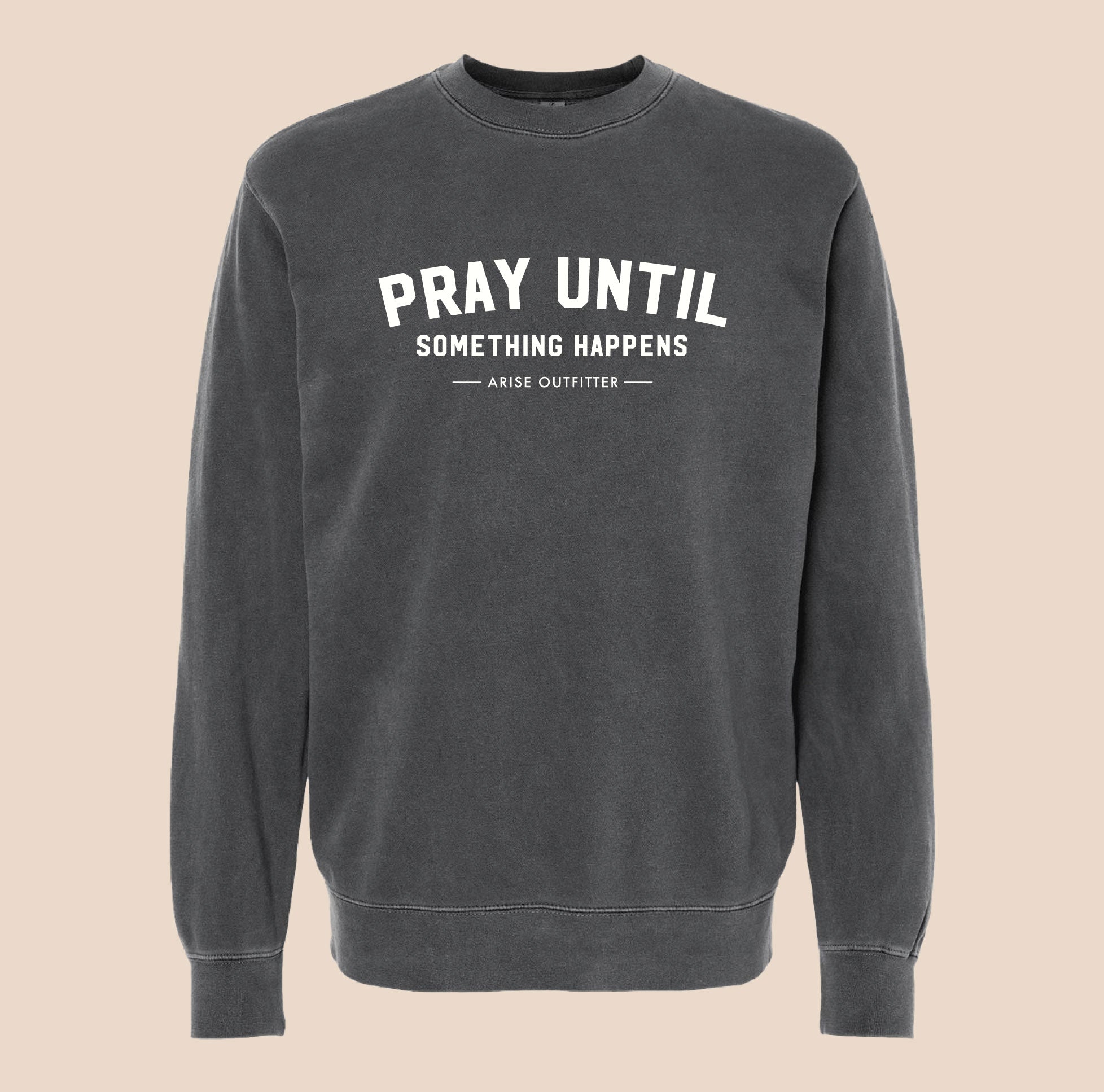 Black sweatshirt with 'Pray Until Something Happens' text on a beige background