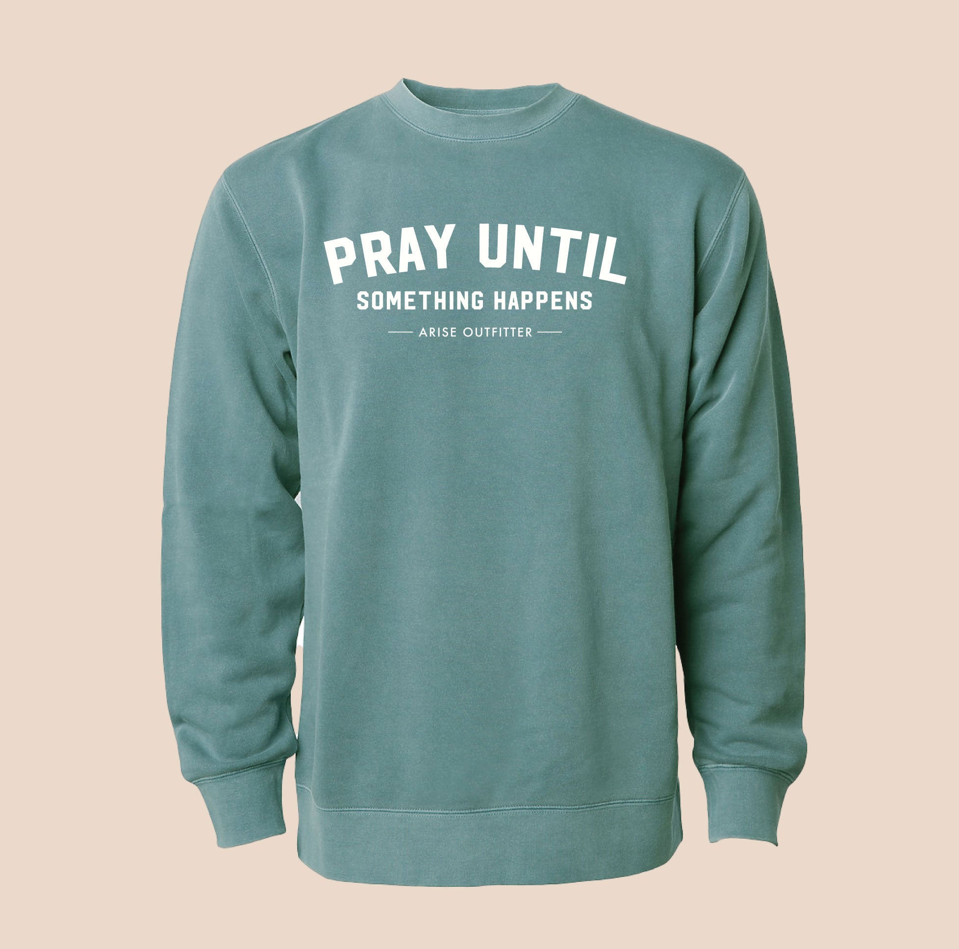 Green sweatshirt with text 'PRAY UNTIL SOMETHING HAPPENS' on a beige background